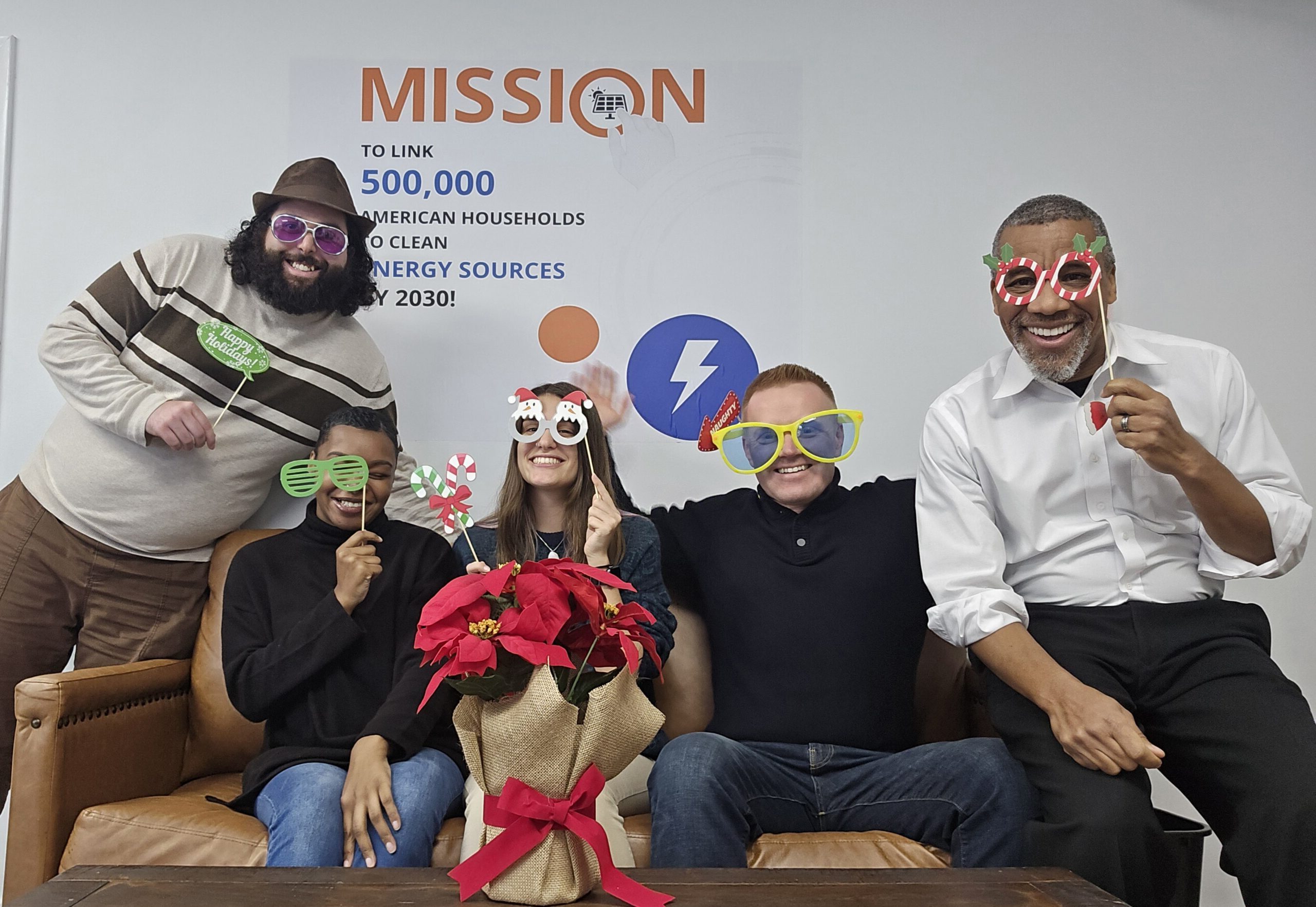 Finray Solar employees in front of our Mission wall